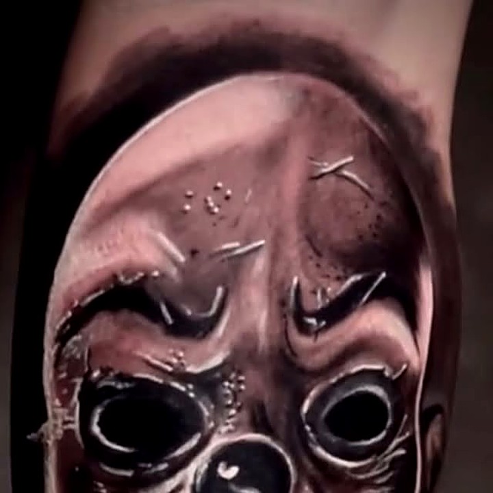Black and grey skull mask tattoo