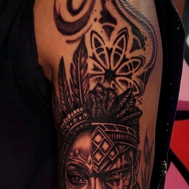 Black and grey ornamental arm tattoo with mandala and portrait