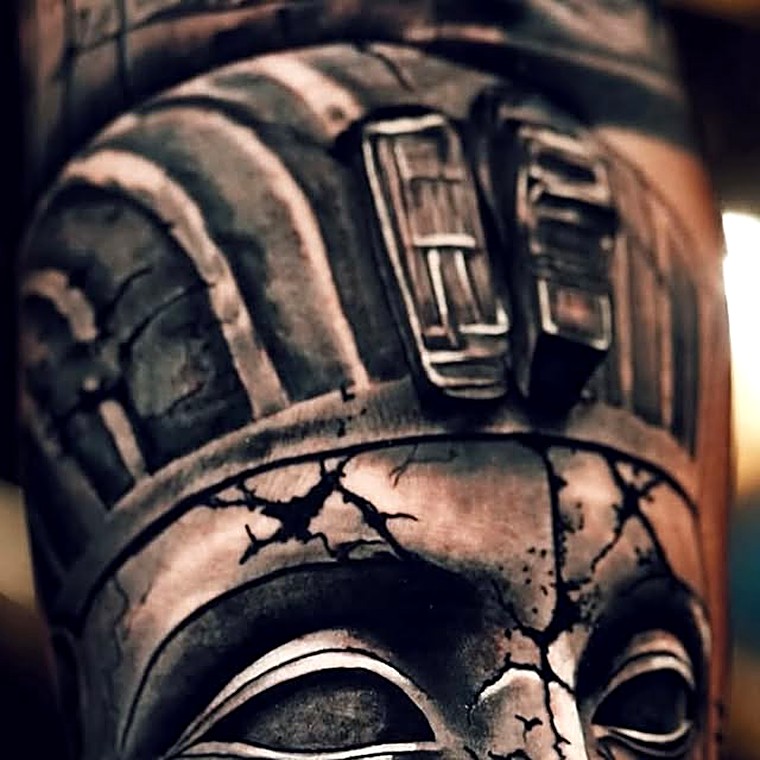 Large black and grey tattoo of a pharaoh's headdress